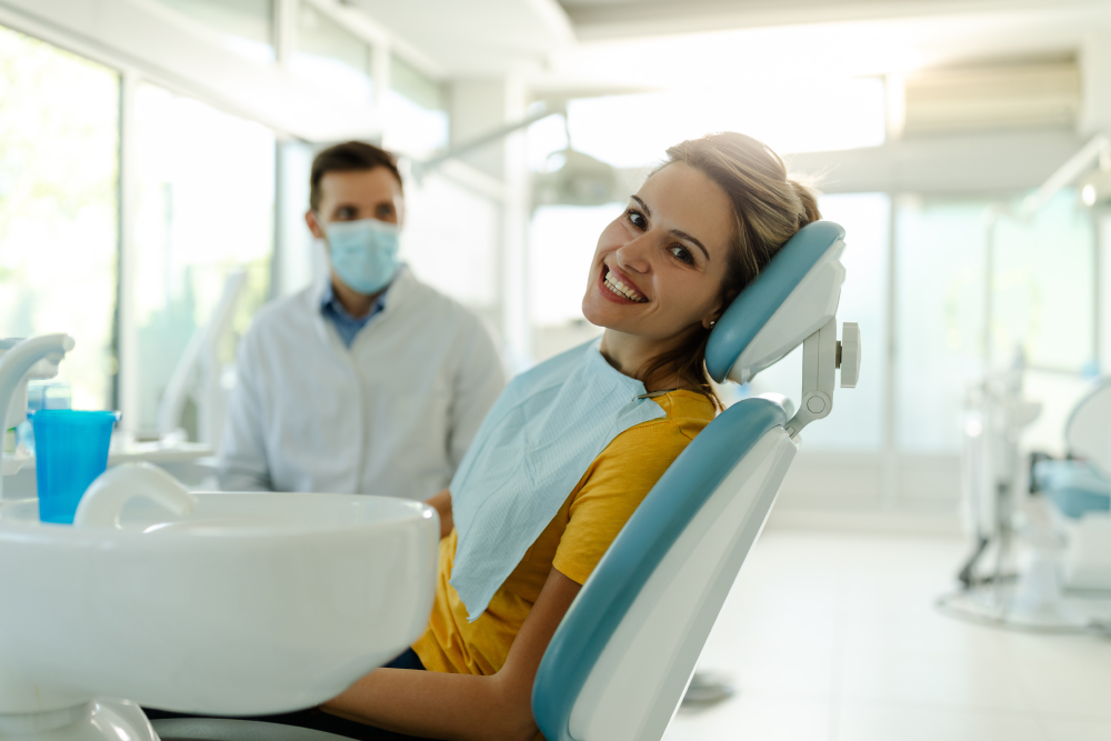 Patient sitting and smiling in dental chair