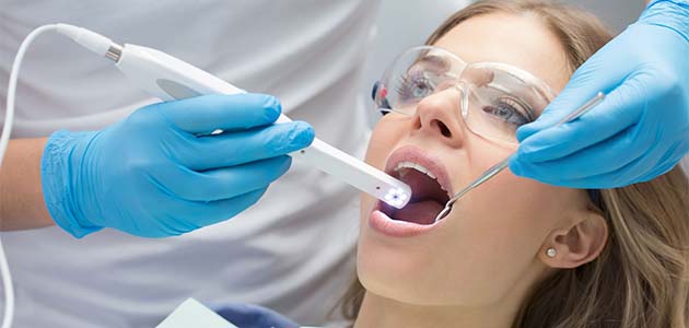 Dentist inspecting women patients mouth