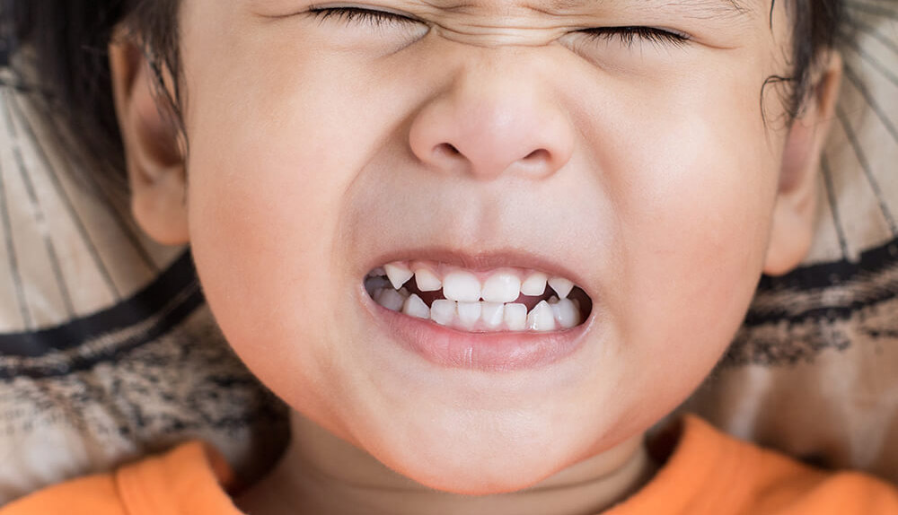 a child grinding his teeth